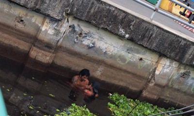 Casal é flagrado tomanho banho de rio nas águas poluídas do centro de Manaus
