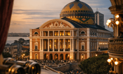 Teatro Amazonas in Manaus, Brazil, illuminated at dusk with a crowd gathered outside