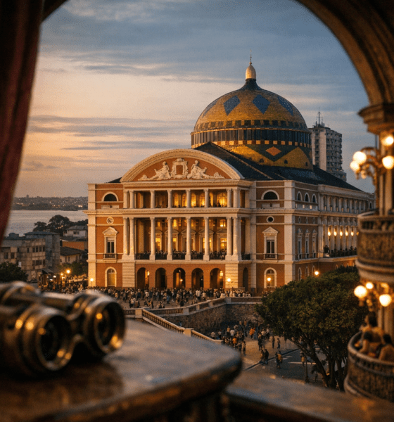Teatro Amazonas in Manaus, Brazil, illuminated at dusk with a crowd gathered outside